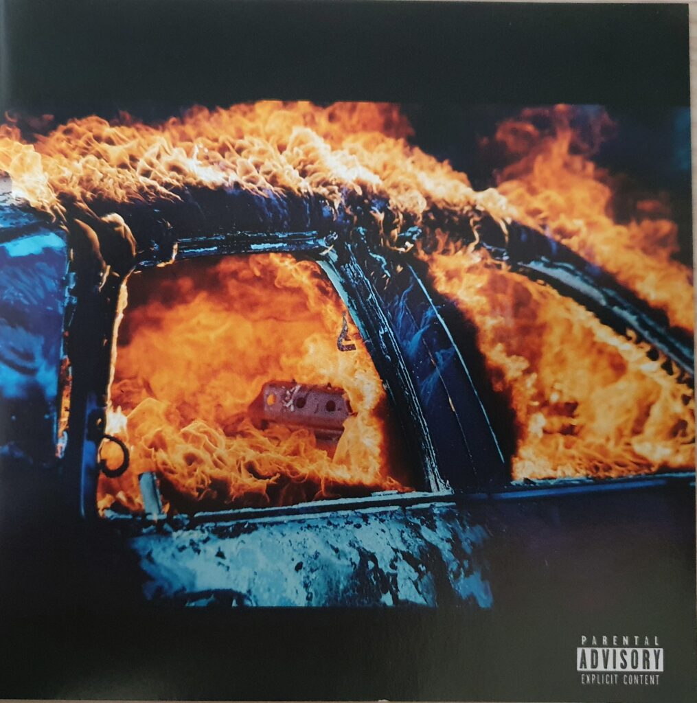 Cover of "Trial by Fire" from Yelawolf, which shows a burning car.